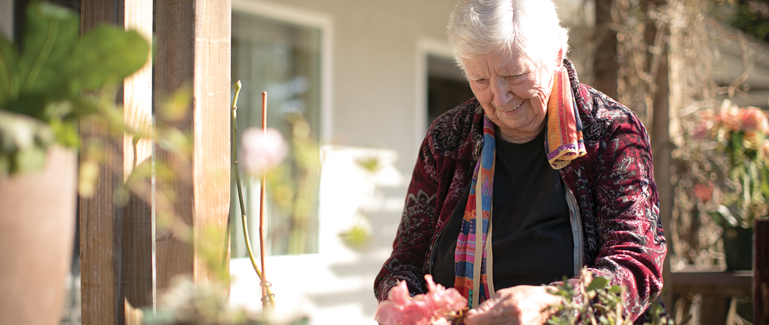 Bright, cheerful memory care resident enjoying the outdoors.